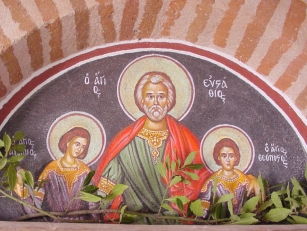 Τοιχογραφία που βρίσκεται πάνω από την είσοδο του ναού του Αγίου Ευσταθίου στον Μυλοπόταμο.  Αναπαρίστατε ο Άγιος με τα τέκνα του.